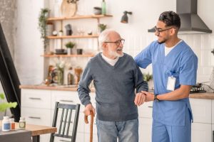 Caregiver helping an older adult walk