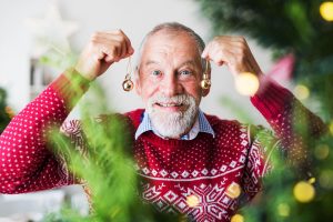 Older adult with Christmas decorations.