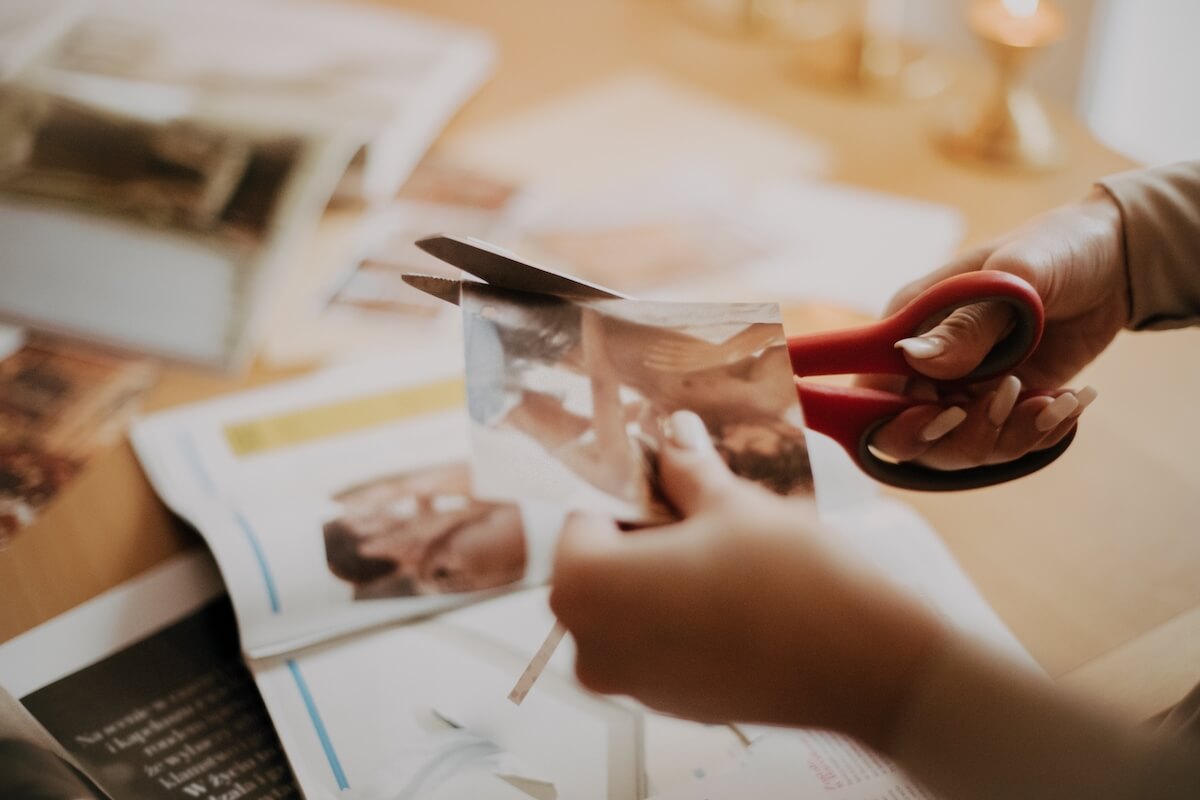 Older woman cutting a picture